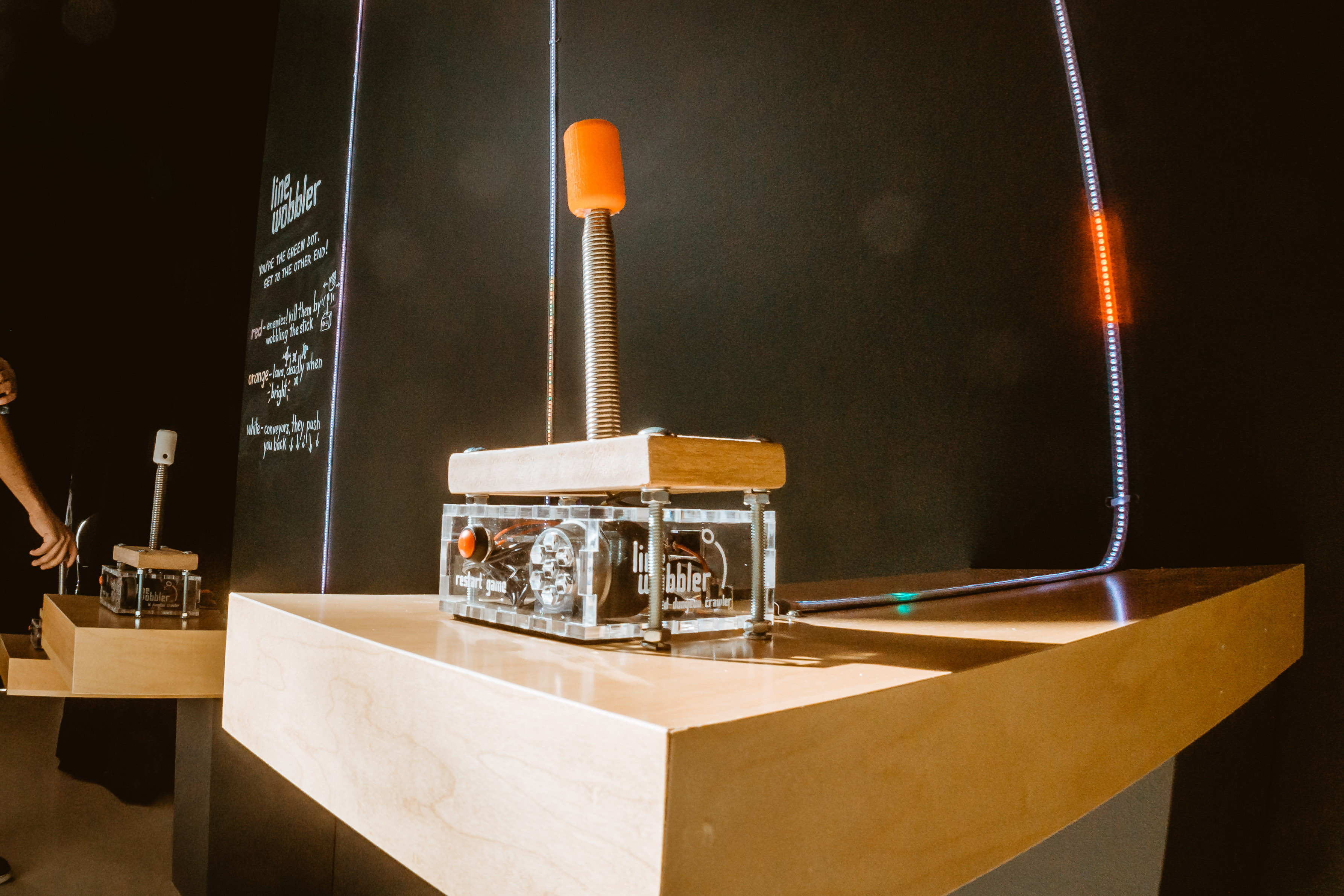 A  promotional image for Line Wobbler featuring the build of the spring door stop controller that the game uses to control the LED strip.